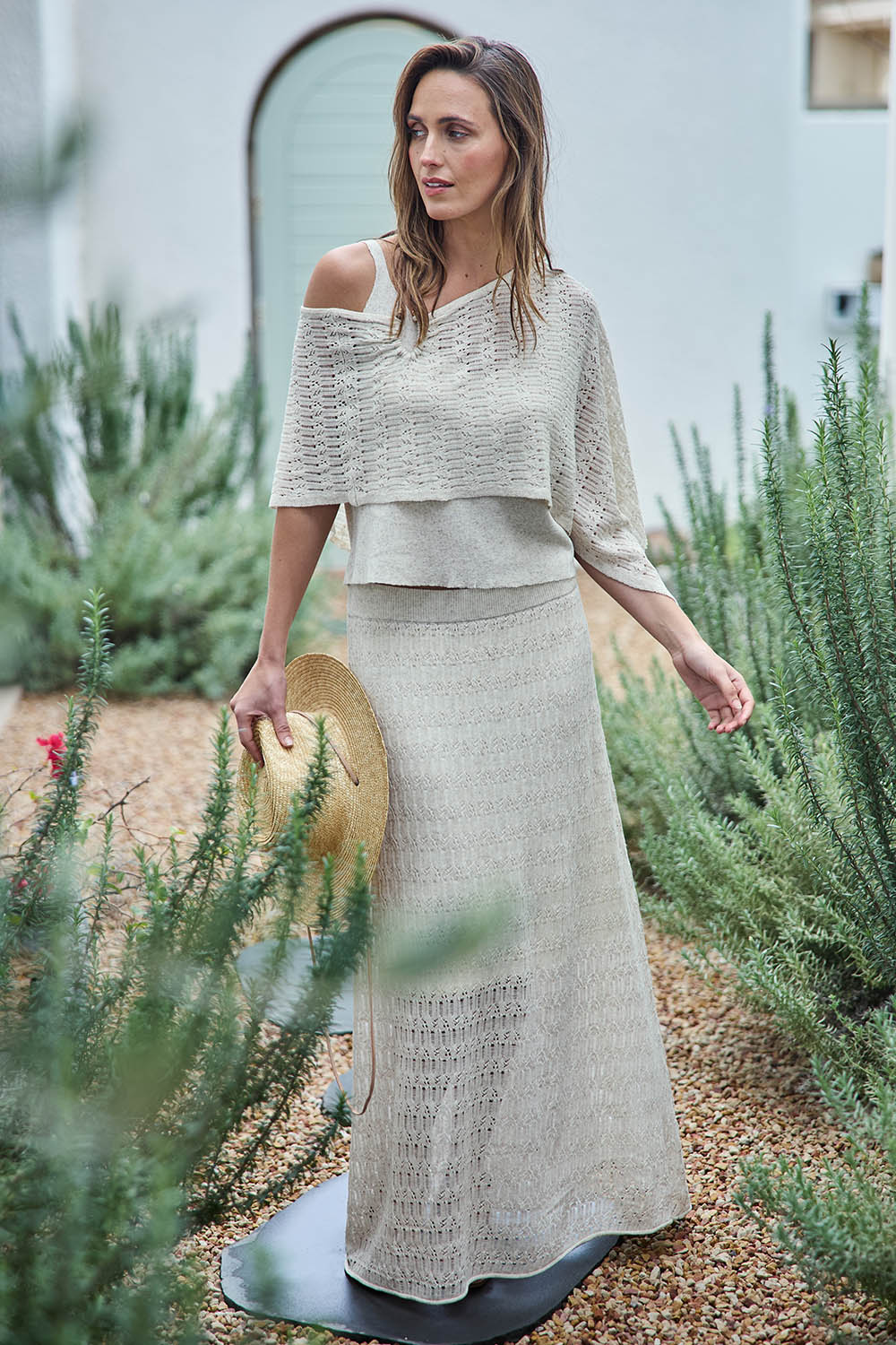 Model Tegand wearing size 10 of the Golden Hour Knit Top And Poncho Set - Natural in colour Natural, from the front