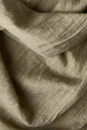 Product shot of the Floating Through The Day Scarf - Olive in colour Olive, from the back