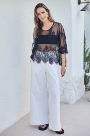 Model Tegand wearing size 10 of the Last Dance Lace Throw Top - Black in colour Black, from the front