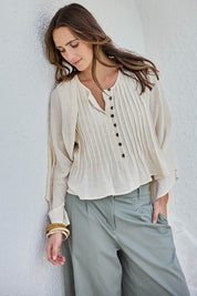 Model Tegand wearing size 10 of the Out Of Office Woven Cotton Shrug  - Sand in colour Sand, in a cropped view