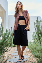Model Tegand wearing size 10 of the Out Of Office Woven Cotton Longline Shorts - Black in colour Black, from the front