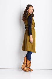 Model Clementine wearing size 8 of the Round Em Up Vest in colour Forest (Green), from the back