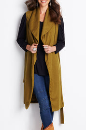Model Clementine wearing size 8 of the Round Em Up Vest in colour Forest (Green), from the front, cropped image