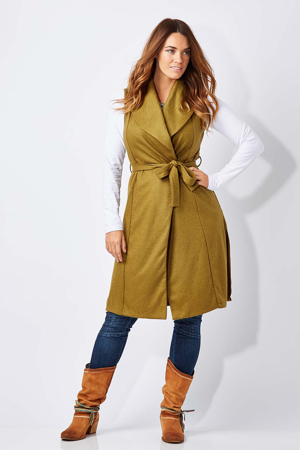 Model Laura wearing size 12 of the Round Em Up Vest in colour Forest (Green), from the front, showing the whole outfit