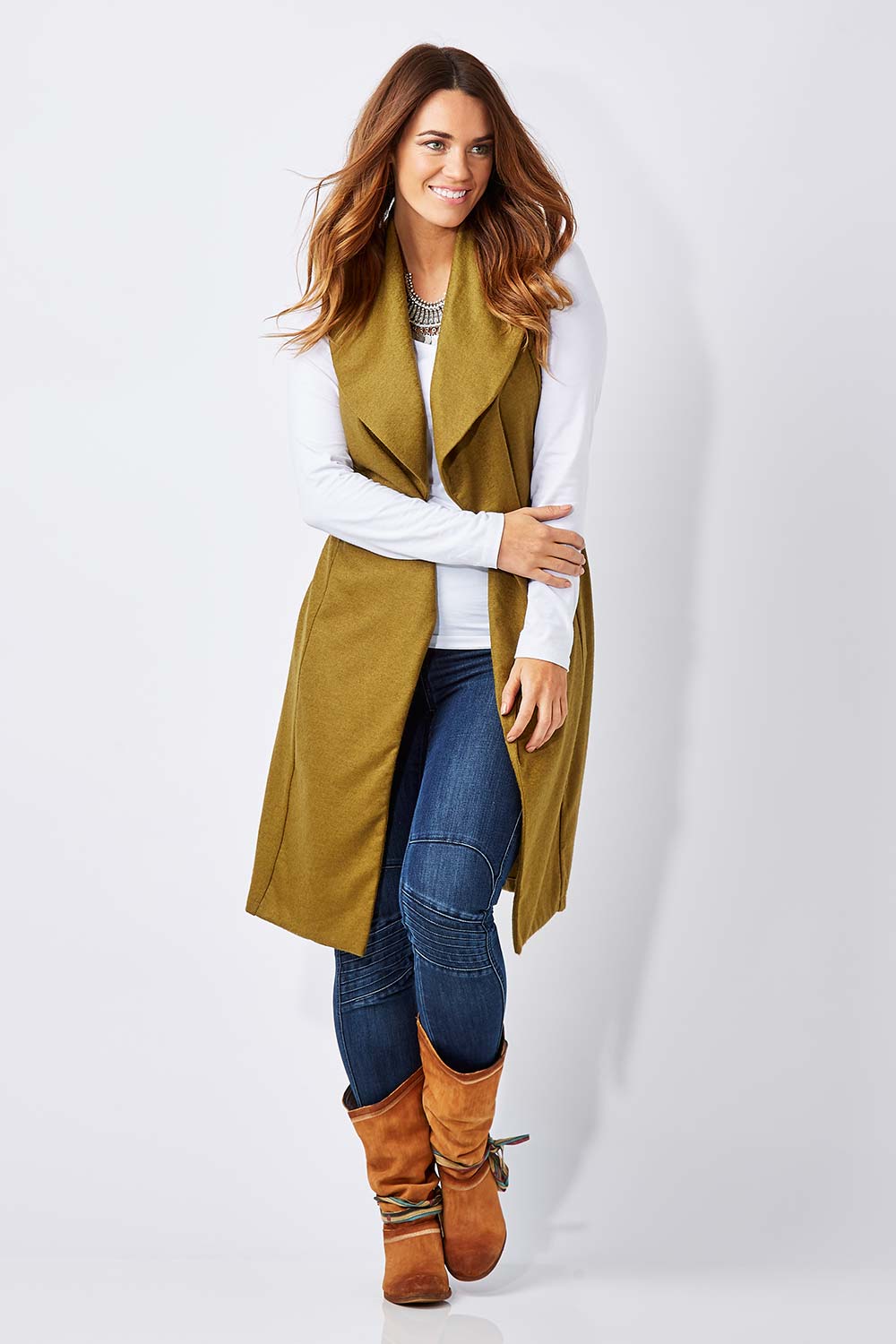 Model Laura wearing size 12 of the Round Em Up Vest in colour Forest (Green), from the front, showing the whole outfit
