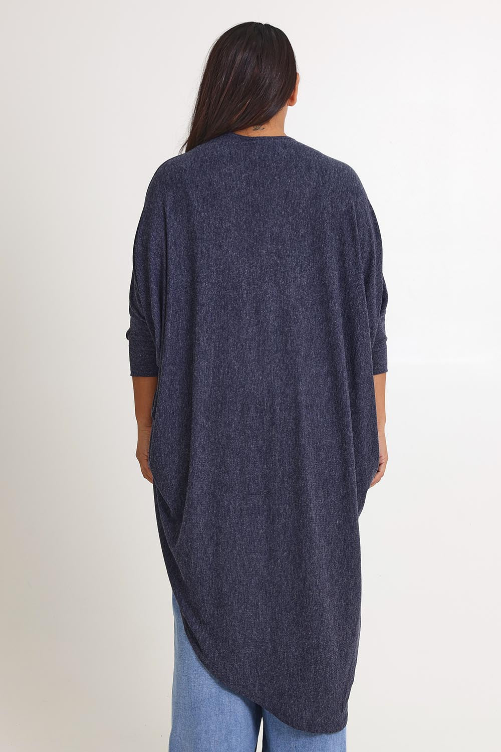 Model Ashleigh wearing size 16 of the Falling For You Cardi in colour Denim (Blue), from the back