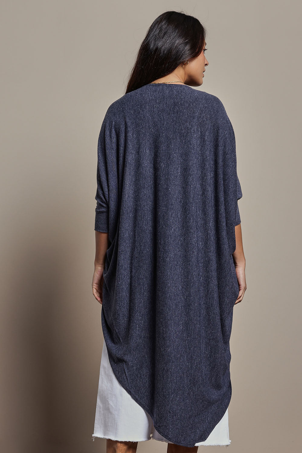 Model Tahnee wearing size 10 of the Falling For You Cardi in colour Denim (Blue), from the back