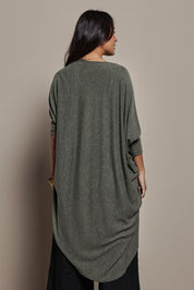 Model Tahnee wearing size 10 of the Falling For You Cardi in colour Pine (Green), from the back
