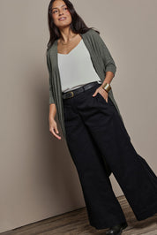 Model Tahnee wearing size 10 of the Falling For You Cardi in colour Pine (Green), from the front, showing the whole outfit