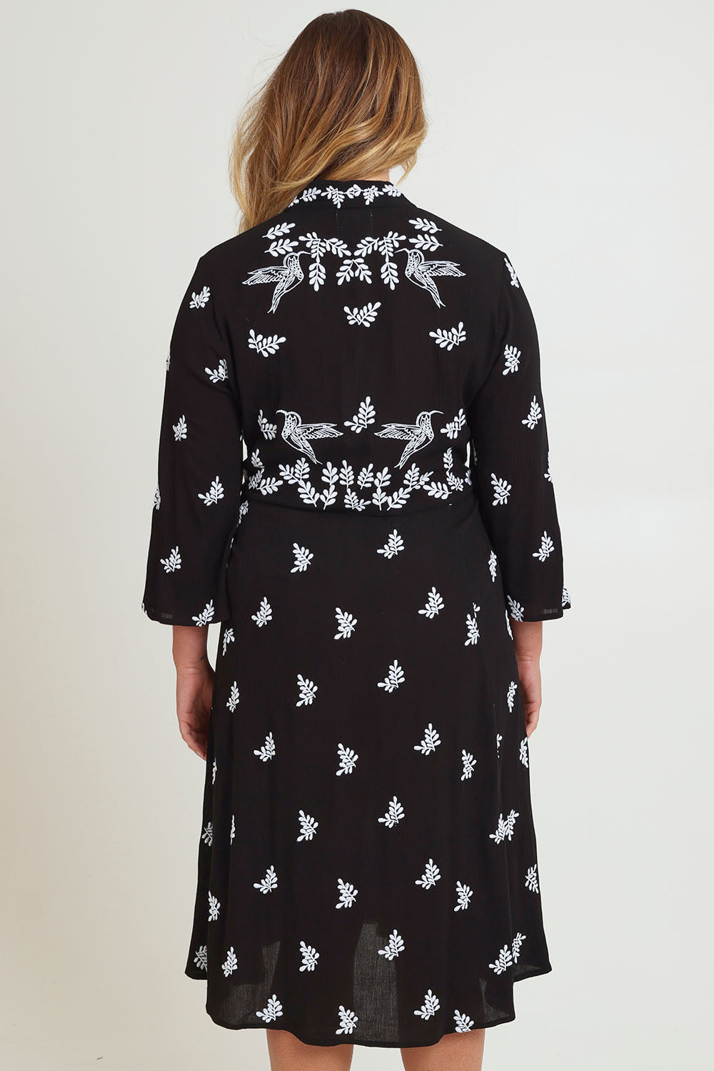 Model Chanel wearing size 16 of the Dancing With Birds Midi Dress in colour Black (Black), from the back