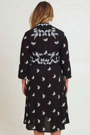 Model Chanel wearing size 16 of the Dancing With Birds Midi Dress in colour Black (Black), from the back