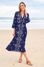 Model Tegan wearing size 10 of the Dancing With Birds Midi Dress in colour Deepblue (Blue), from the front, showing the whole outfit