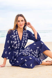 Model Tegan wearing size 10 of the Dancing With Birds Midi Dress in colour Deepblue (Blue), from the front, showing the whole outfit