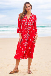Model Tegan wearing size 10 of the Dancing With Birds Midi Dress in colour Scarlet (Red), from the front, showing the whole outfit