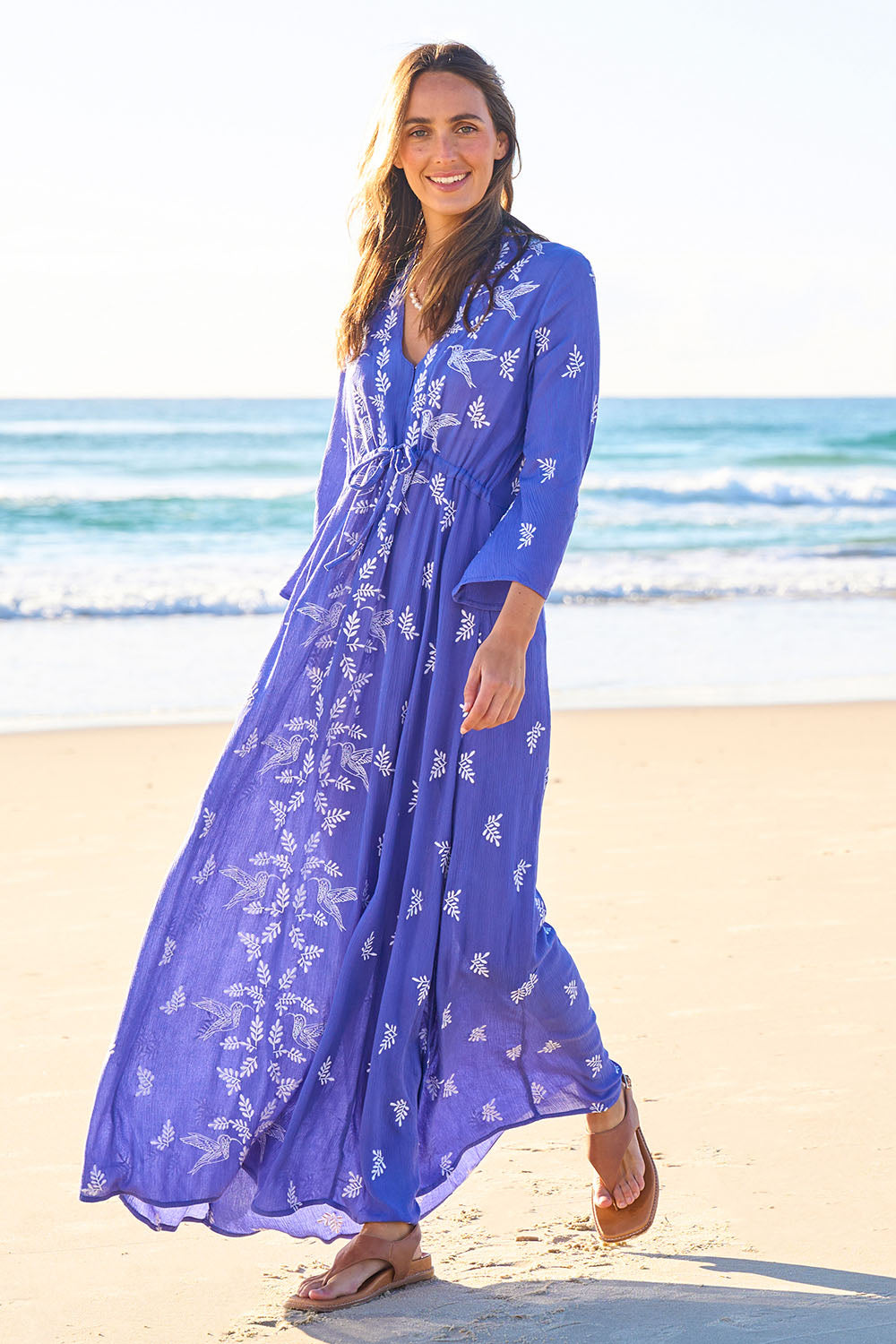 Model Tegan wearing size 10 of the Dancing With Birds Dress in colour Persian (Blue), from the front, showing the whole outfit