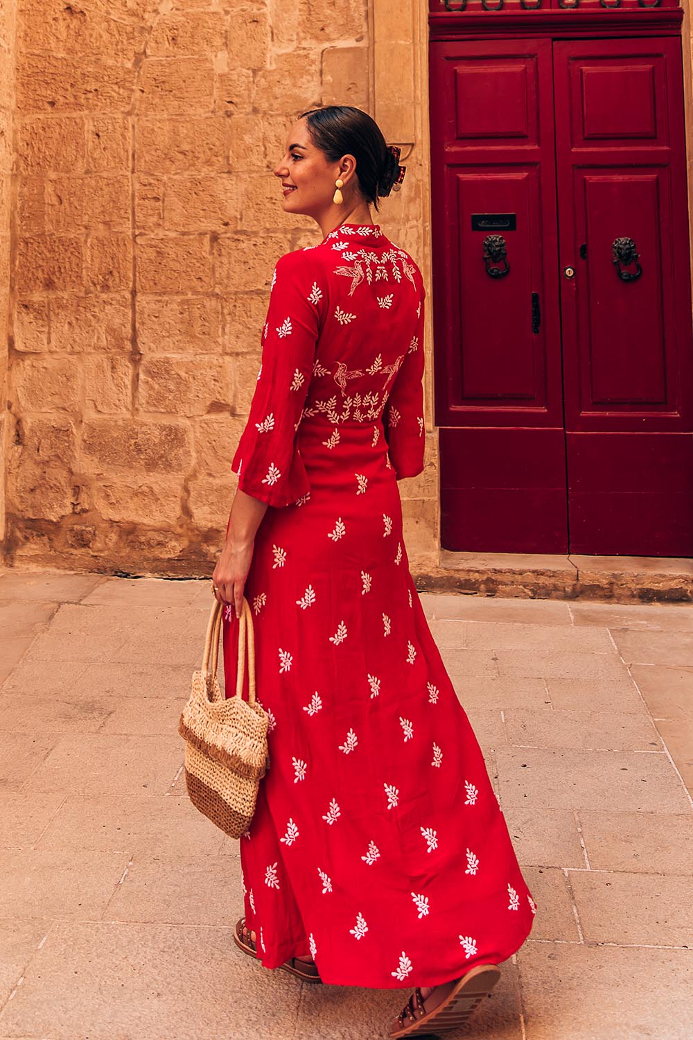 A model wearing the Dancing With Birds Dress in colour Scarlet (Red), from the front, showing the whole outfit