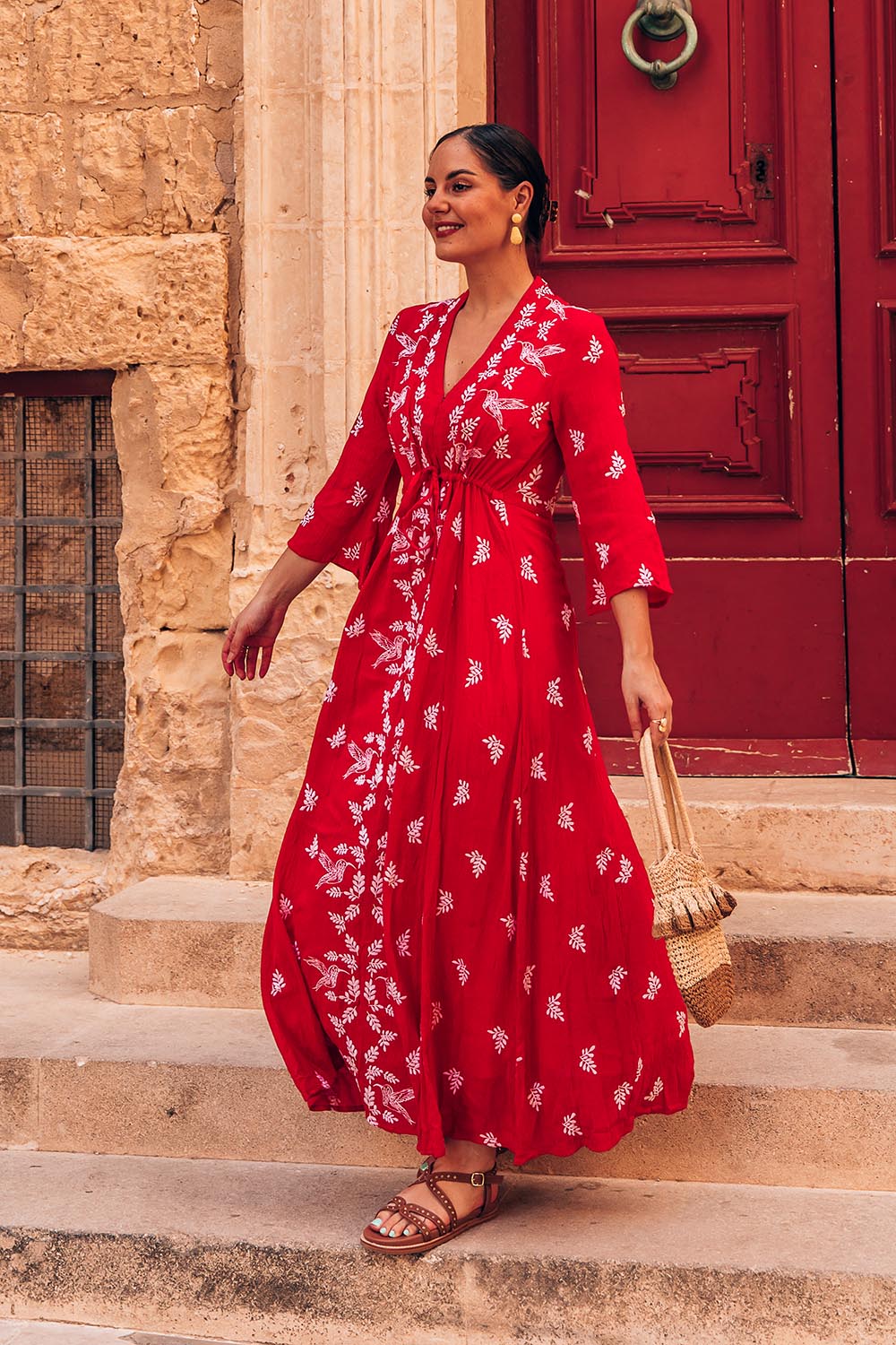 A model wearing the Dancing With Birds Dress in colour Scarlet (Red), from the front, showing the whole outfit