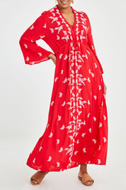 Model Noli wearing size 14 of the Dancing With Birds Dress in colour Scarlet (Red), from the front, cropped image