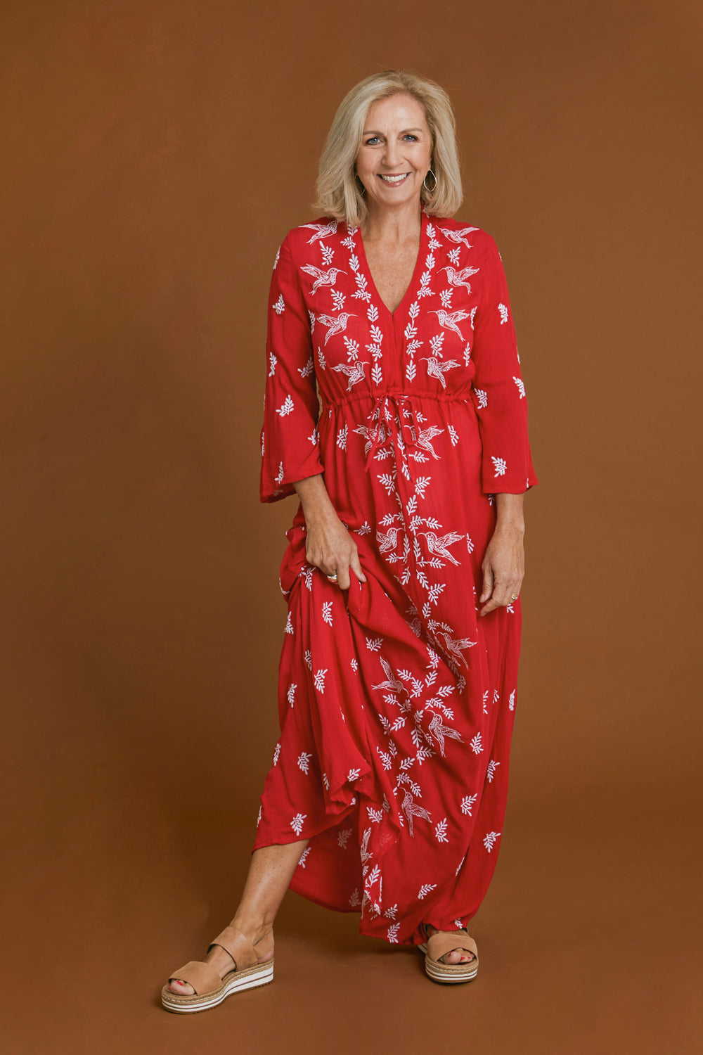 Model Sandy wearing size 10 of the Dancing With Birds Dress in colour Scarlet (Red), from the front, showing the whole outfit