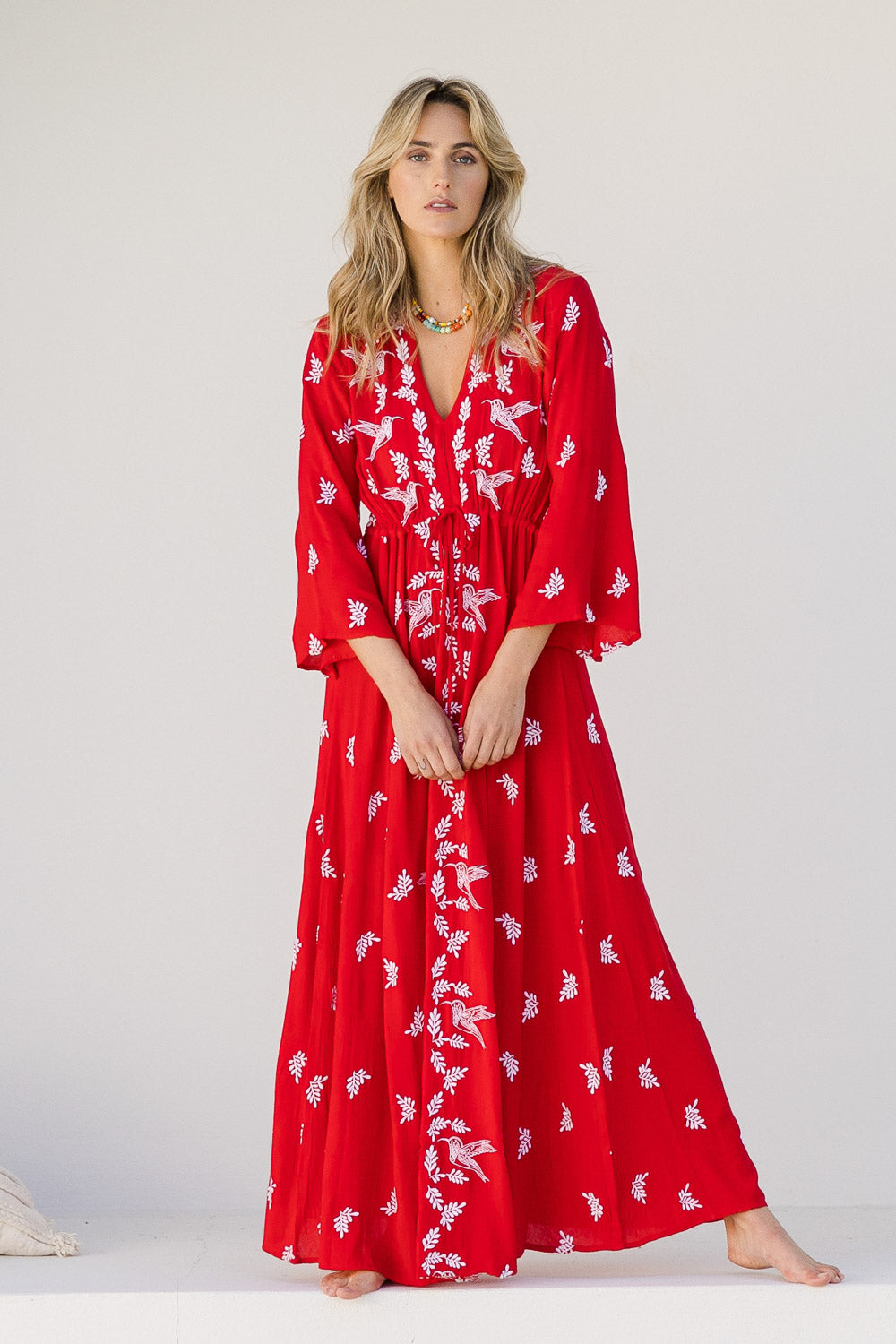 Model Tegan wearing size 10 of the Dancing With Birds Dress in colour Scarlet (Red), from the front, showing the whole outfit