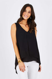 Model Georgia wearing size 10 of the Sugar Snaps Layers Tank in colour Black (Black), from the front, cropped image