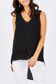 Model Georgia wearing size 10 of the Sugar Snaps Layers Tank in colour Black (Black), from the front, cropped image