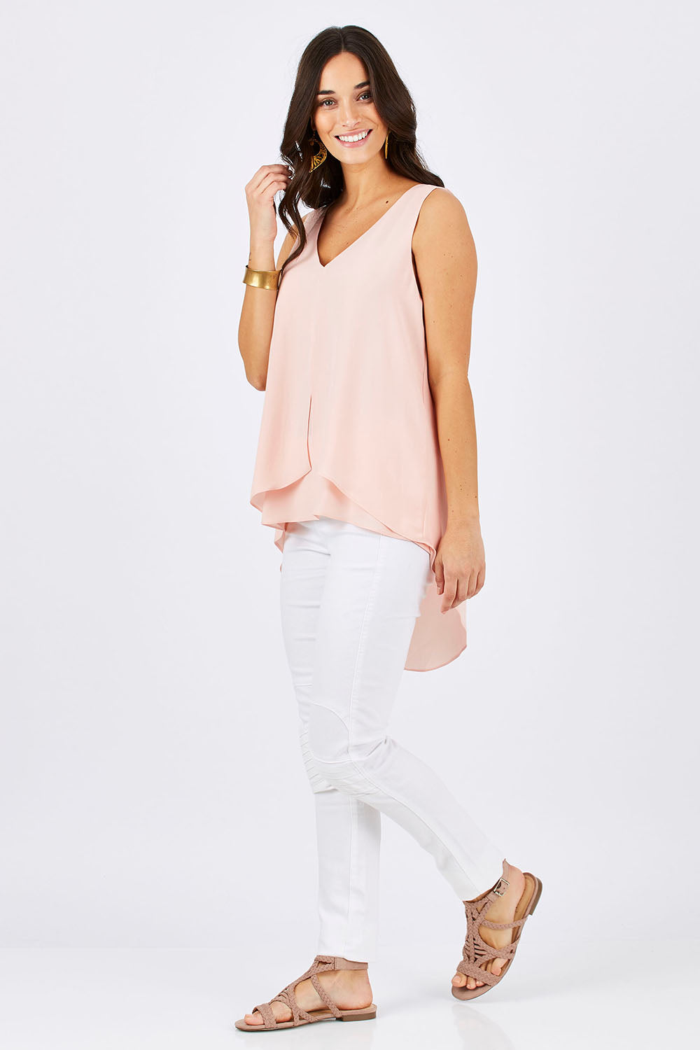 Model Georgia wearing size 10 of the Sugar Snaps Layers Tank in colour PeachyKeen (Pink), from the front, showing the whole outfit