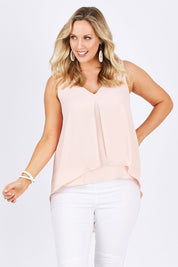 Model Jess wearing size 14 of the Sugar Snaps Layers Tank in colour PeachyKeen (Pink), from the front, cropped image