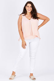 Model Mae wearing size 18 of the Sugar Snaps Layers Tank in colour PeachyKeen (Pink), from the front, showing the whole outfit
