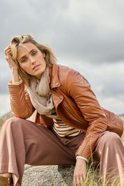 Model Tegan wearing size 10 of the Urban Nomad Leather Jacket in colour Tan, from the front, showing the whole outfit