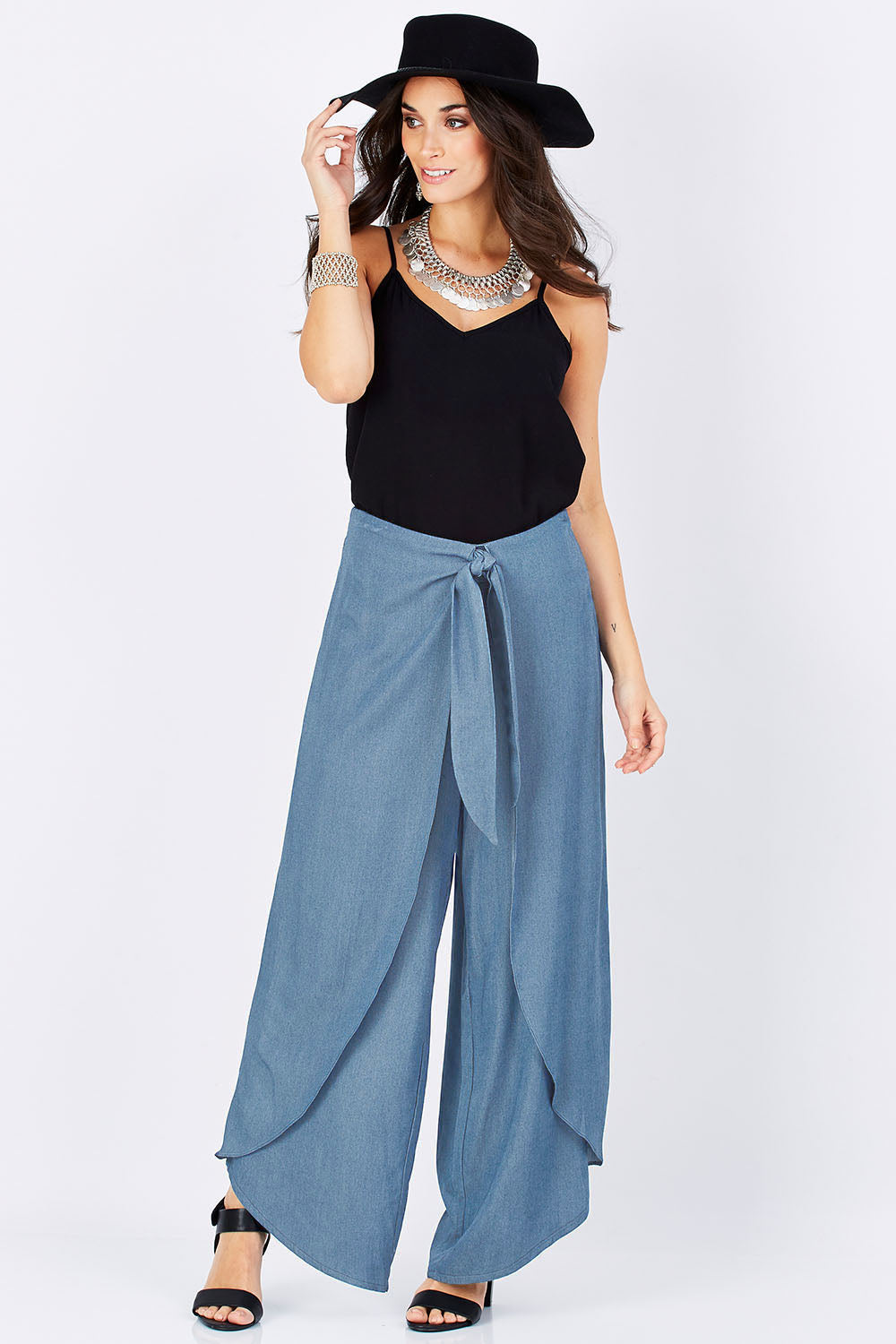 Model Georgia wearing size 10 of the Wrapped In You Pants in colour Denim (Blue), from the front, showing the whole outfit