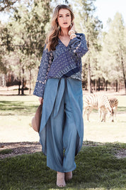 Model Marnee wearing size 10 of the Wrapped In You Pants in colour Denim (Blue), from the front, showing the whole outfit