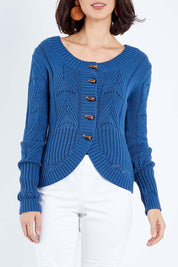 Model Andrea wearing size S of the Fireside Button Cardigan in colour Bluejean (Blue), from the front, cropped image