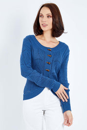 Model Andrea wearing size S of the Fireside Button Cardigan in colour Bluejean (Blue), from the front, cropped image