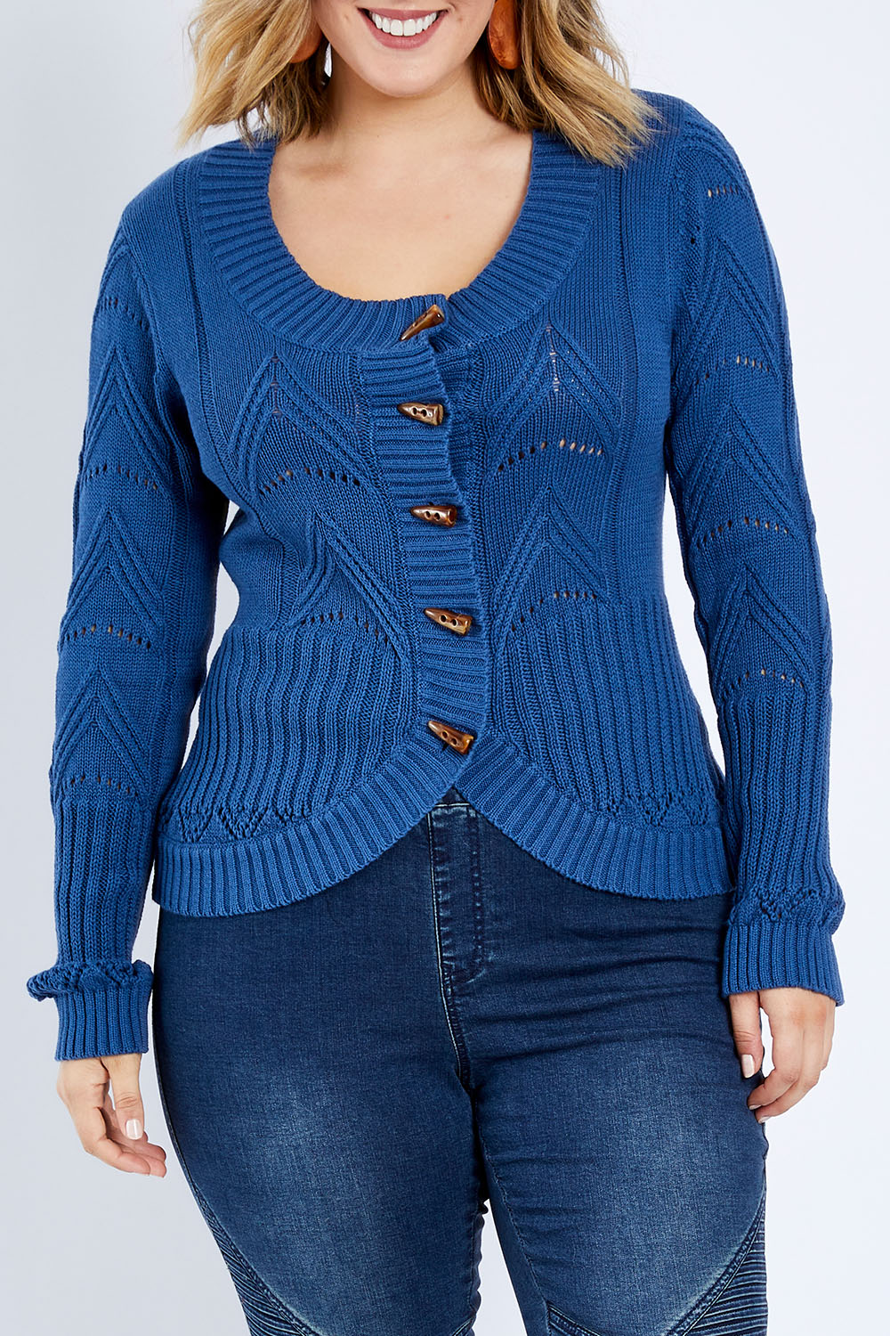 Model Jess wearing size L of the Fireside Button Cardigan in colour Bluejean (Blue), from the front, cropped image