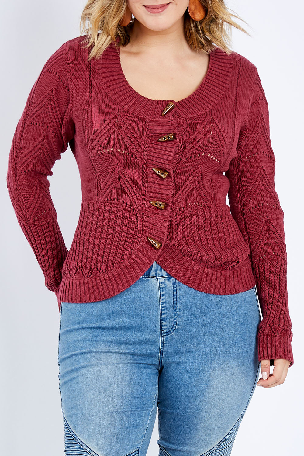 Model Jess wearing size L of the Fireside Button Cardigan in colour Plum (Red), from the front, cropped image