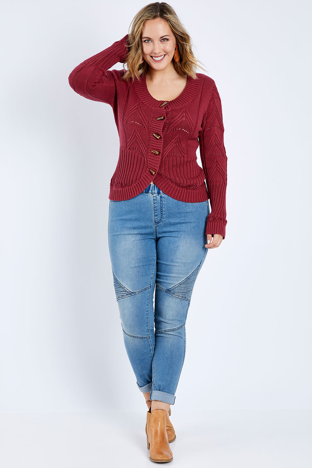 Model Jess wearing size L of the Fireside Button Cardigan in colour Plum (Red), from the front, showing the whole outfit