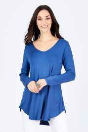 Model Georgia wearing size 10 of the Long Sleeve Softly Swinging Bamboo Tee in colour BlueJeans (Blue), from the front, cropped image