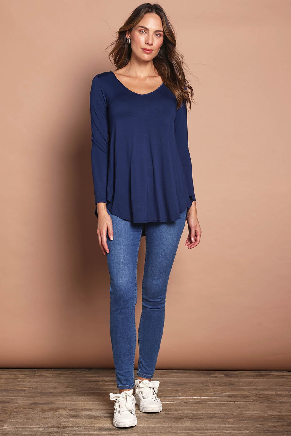 Model Madeline wearing size 10 of the Long Sleeve Softly Swinging Bamboo Tee in colour Navy (Blue), from the front, showing the whole outfit