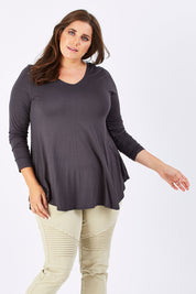 Model Mae wearing size 18 of the Long Sleeve Softly Swinging Bamboo Tee in colour Storm (Grey), from the front, cropped image