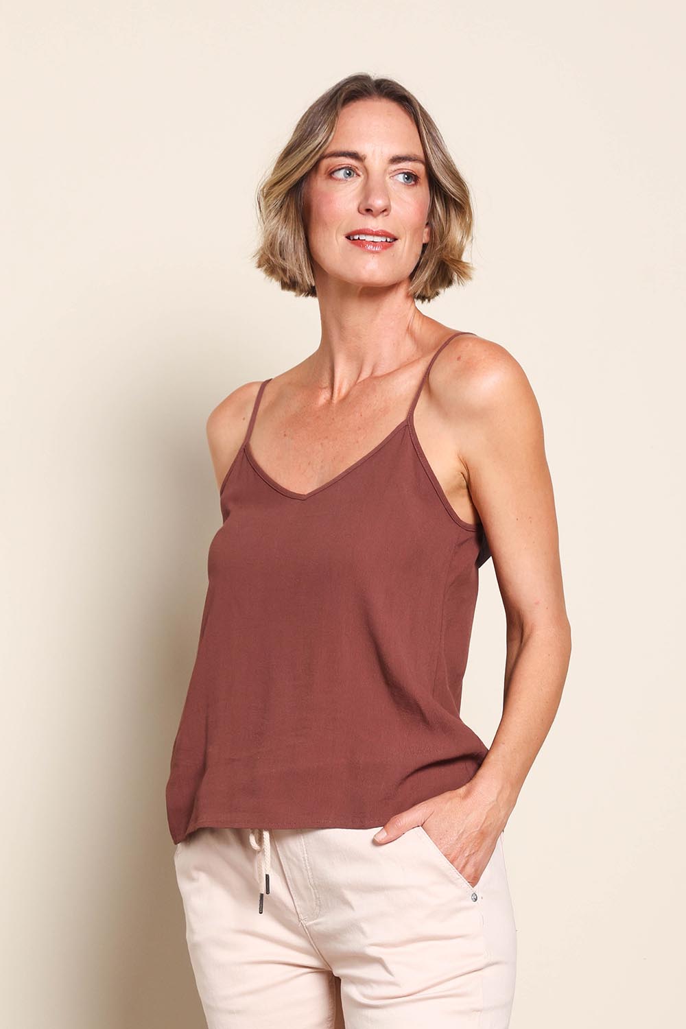 Model Riinar wearing size 10 of the Runaway Top – Chocolate in colour Chocolate, from an angle