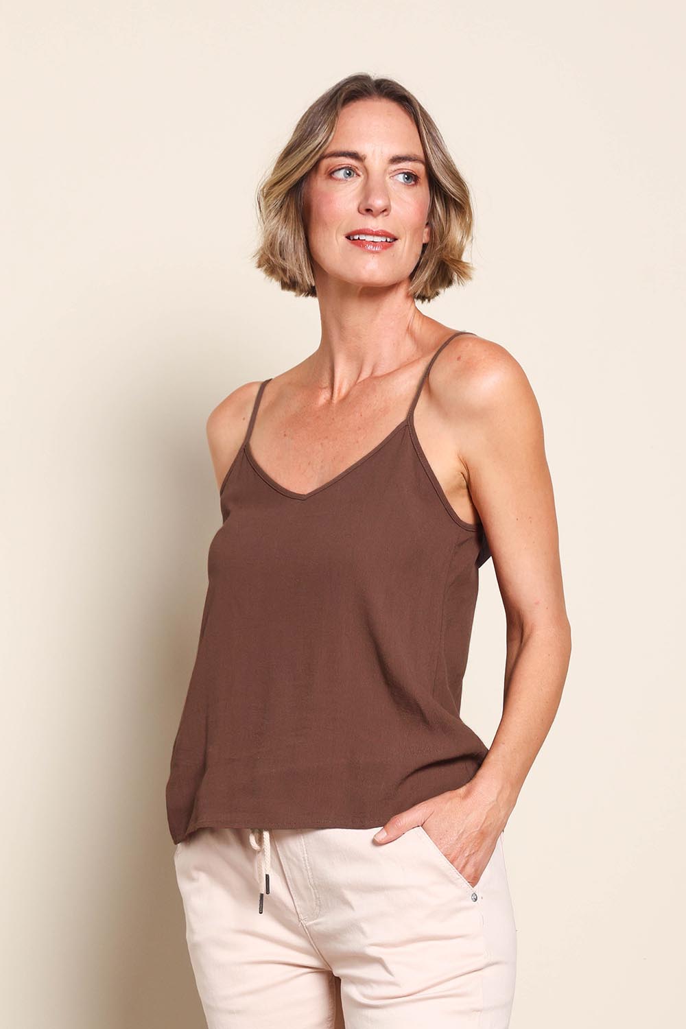 Model Riinar wearing size 10 of the Runaway Top – Chocolate in colour Chocolate, from an angle
