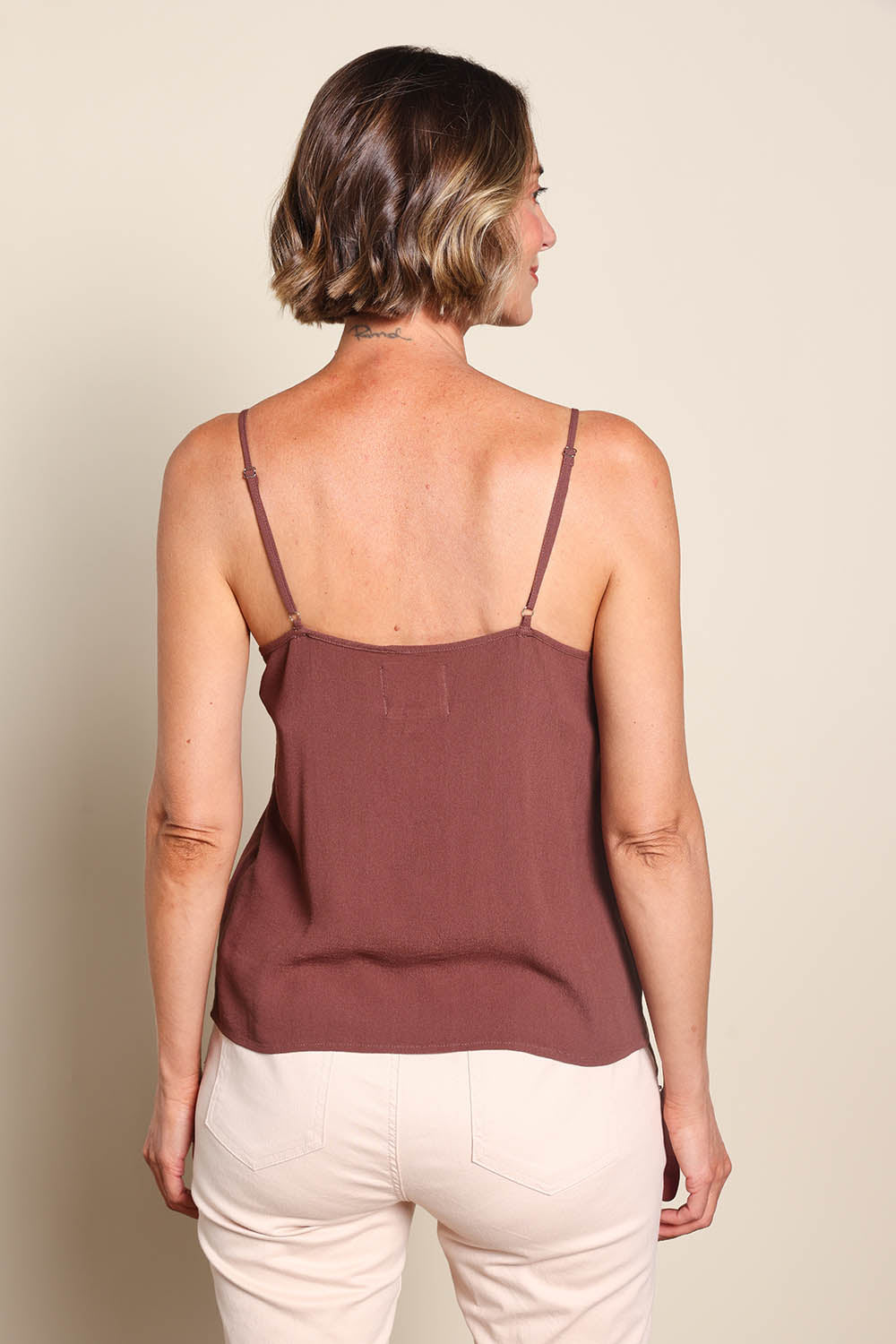 Model Riinar wearing size 10 of the Runaway Top – Chocolate in colour Chocolate, from the back