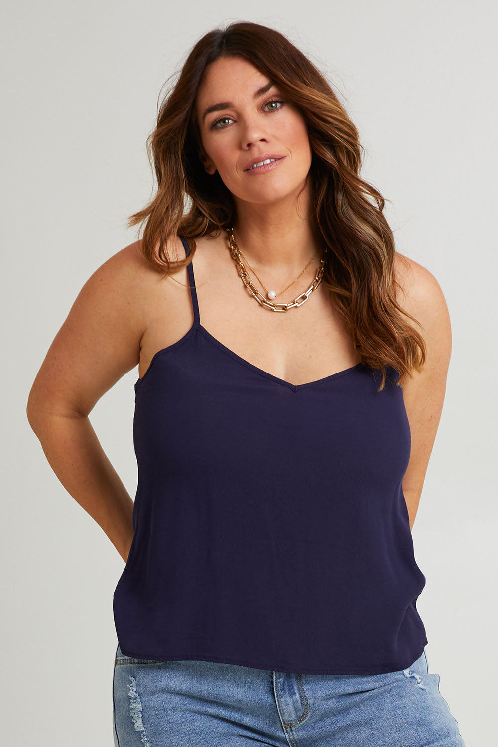 Model Laura wearing size 14 of the Runaway Top in colour Darknavy (Blue), from the front, cropped image