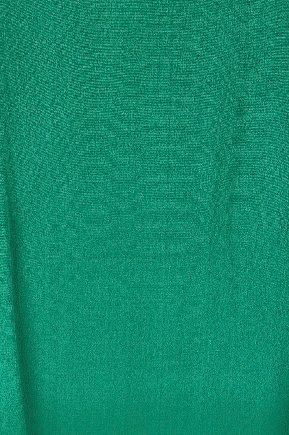 Product shot of the Runaway Top – Emerald in colour Emerald, showing detail