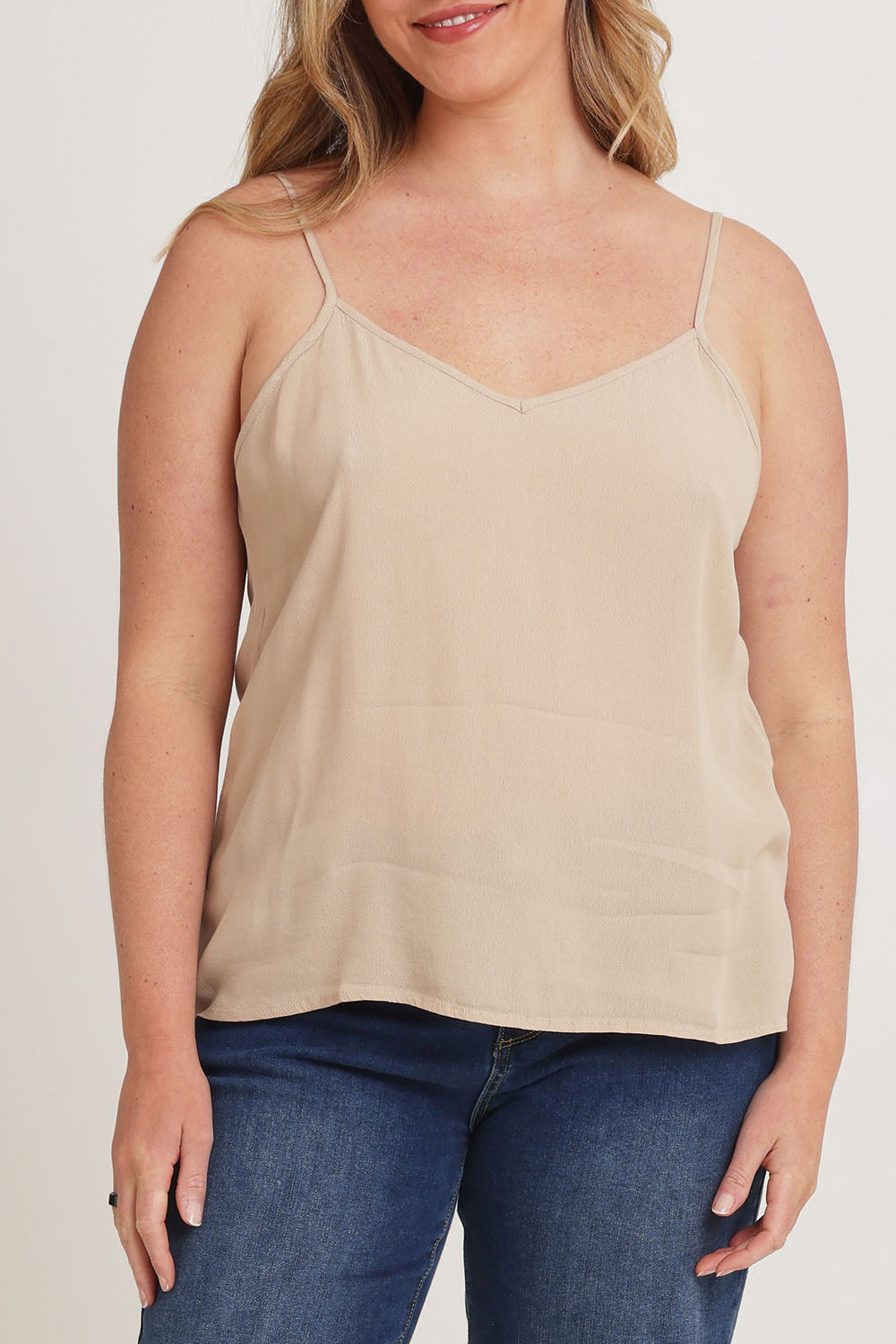 Model Chanel wearing size 16 of the Runaway Top in colour Latte, from the front, cropped image