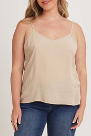 Model Chanel wearing size 16 of the Runaway Top in colour Latte, from the front, cropped image