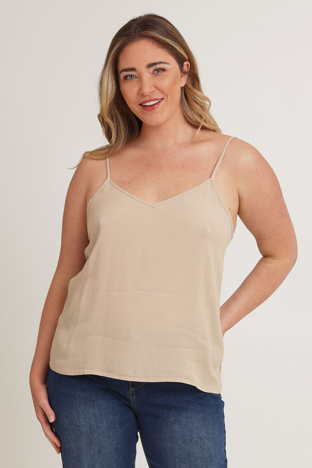 Model Chanel wearing size 16 of the Runaway Top in colour Latte, from the front, cropped image