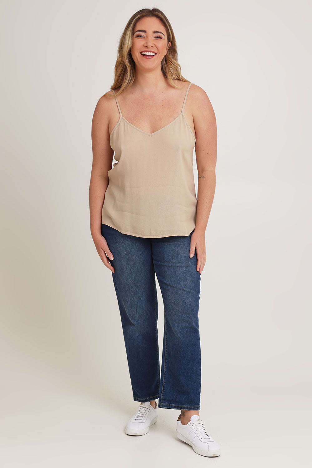 Model Chanel wearing size 16 of the Runaway Top in colour Latte, from the front, showing the whole outfit