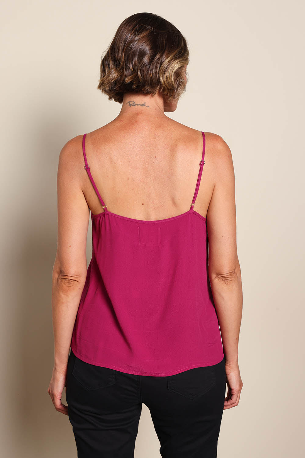 Model Riinar wearing size 10 of the Runaway Top – Plum in colour Plum, from the back